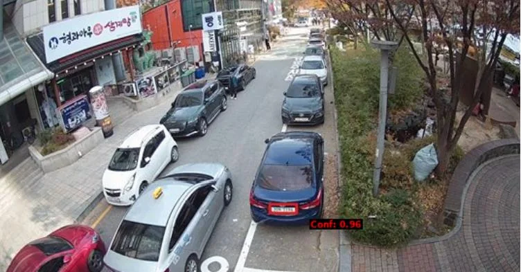 Plate detection on a street-level CCTV frame (confidence 0.96) — the starting point for restoration and OCR.